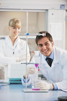 science and research biology chemistry an dmedicine  youn people couple in bright modern  lab