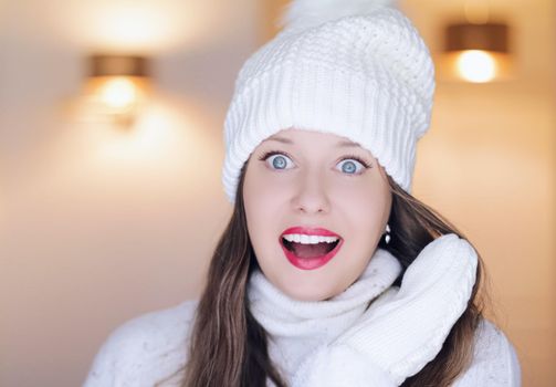 Christmas, people and winter holiday concept. Happy smiling woman wearing white knitted hat as closeup face xmas portrait.