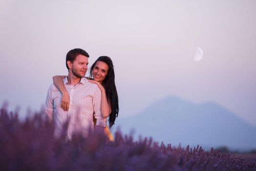 couple in purple lavender flower  field kissing and have romantic time in sunset