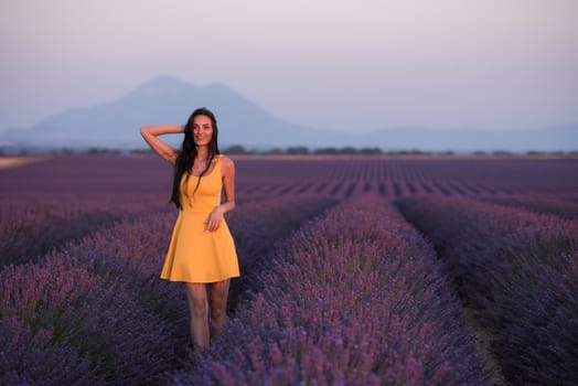 lavander field woman in yellow dress having fun and relax on  purple flower field