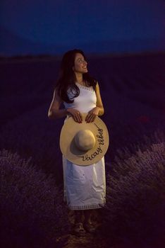 woman portrait in lavender flower fiel in sunset and night time