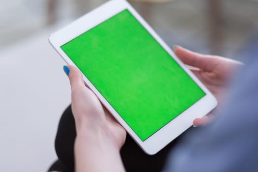 young happy woman on sofa using tablet computer at luxury home