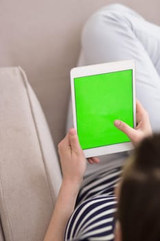 young happy woman on sofa using tablet computer at luxury home