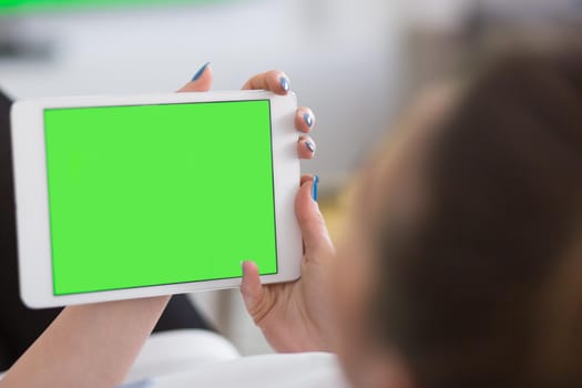 young happy woman on sofa using tablet computer at luxury home