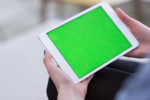 young happy woman on sofa using tablet computer at luxury home