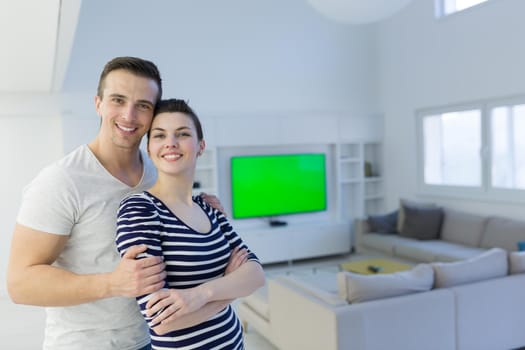 Portrait of a happy young beautiful couple hugging in their new home