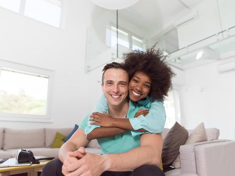 Beautiful young multiethnic couple hugging in their new apartment