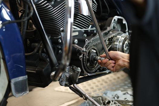 Dismantling motorcycle engine in service center. Diagnostics and service of engine concept