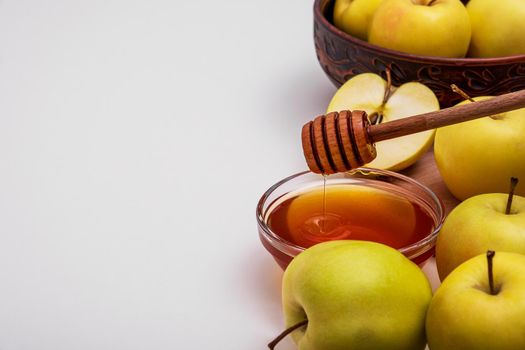 Fresh ripe whole and cut yellow apples with honey lie on table. Selective focus. Copy space.