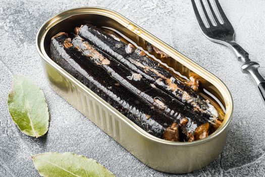 Open canned fish set, on gray stone table background