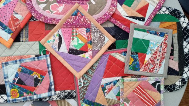 Colorful handmade textiles. Colored fabric patchwork background. Patchwork background. Multicolored patchwork knitted background.