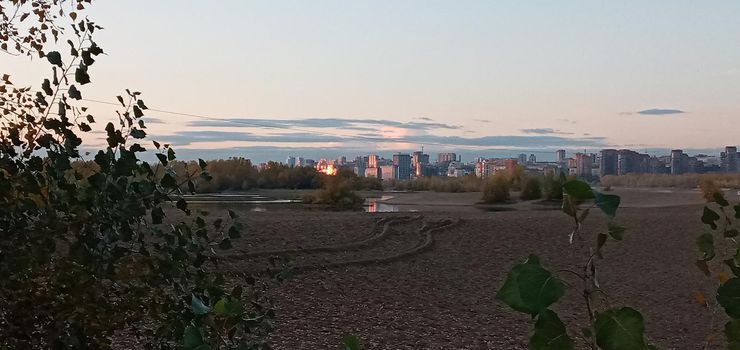 Novosibirsk, Siberia, Russia-08.15.2020: Panorama of Novosibirsk on the Ob river. The capital of Siberia on the great Siberian river, bridges, lush vegetation on river Islands, city buildings