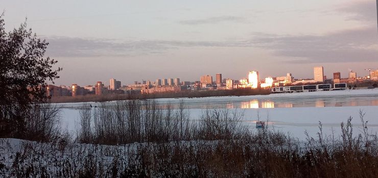 Novosibirsk, Siberia, Russia-08.15.2020: Panorama of Novosibirsk on the Ob river. The capital of Siberia on the great Siberian river, bridges, lush vegetation on river Islands, city buildings