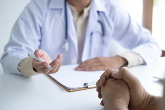 Doctor comforting patient at consulting room