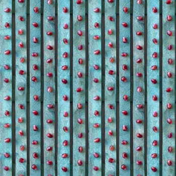 Seamless textured background. Red pomegranate seeds on a turquoise board. 4 fragments in one.