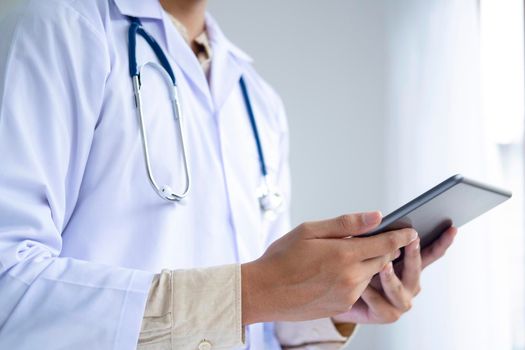 Healthcare and medicine. Doctor using a digital tablet computer at work.