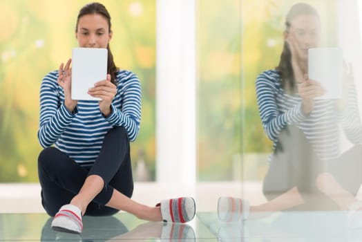 beautiful young women using tablet computer on the floor at home