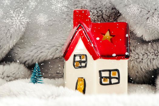 Toy house with red roof, pine tree and snow. New year decoration. Christmas spirit.