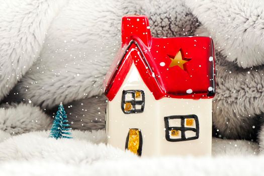 Toy house with red roof, pine tree and snow. New year decoration. Christmas spirit.