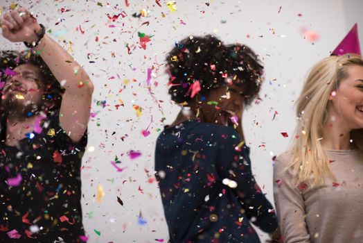 confetti party Multiethnics happy young people group celebrating new year eve while dancing and have fun at home