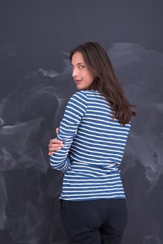 portrait of a young woman standing in front of chalk drawing board