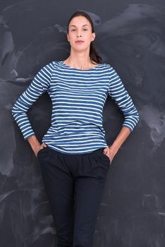 portrait of a young woman standing in front of chalk drawing board