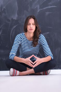 portrait of a young woman sitting in front of chalk drawing board