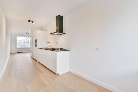 Pretty kitchen with hardwood parquet flooring and black worktop