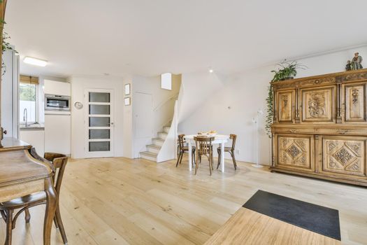 Cozy dining area with round wooden white table and chairs
