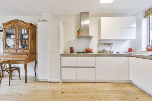 Cozy daylight kitchen with white cabinets and hardwood floors