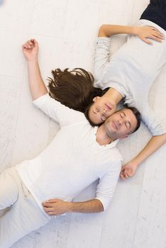 top view of handsome couple lying on floor