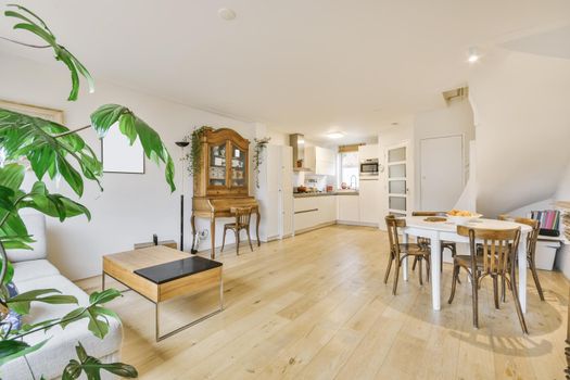 Cozy dining area with round wooden white table and chairs