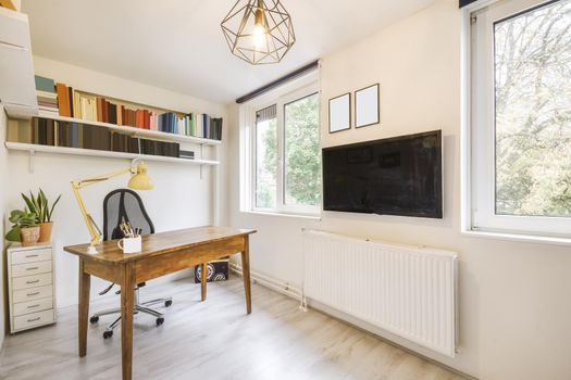 Cozy study area with wooden table and comfortable black chair