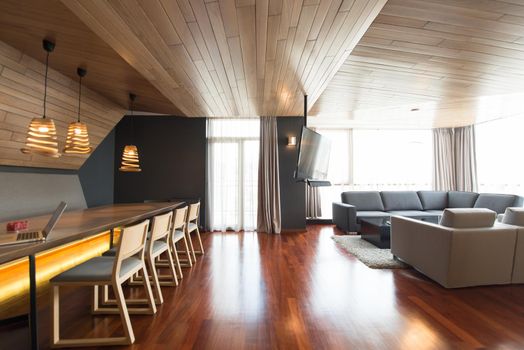 Notebook with blank screen on table in luxury living room.