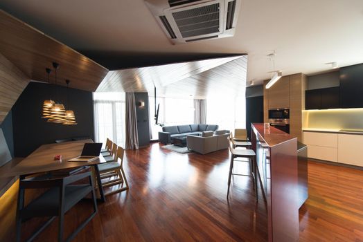 Notebook with blank screen on table in luxury living room.