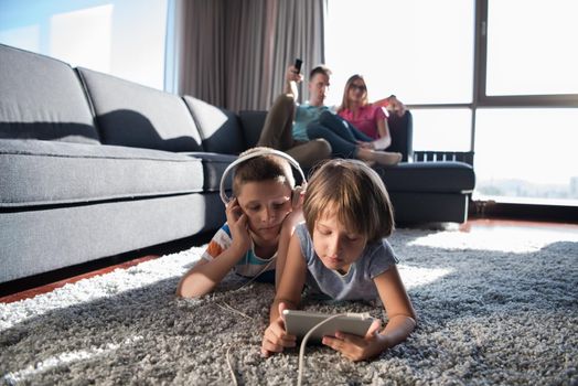 Happy Young Family Playing Together at home.kids using tablet on the floor