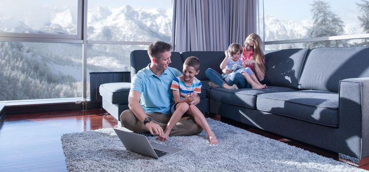 Happy family. Father, mother and children playing a video game Father and son playing video games together on the floor