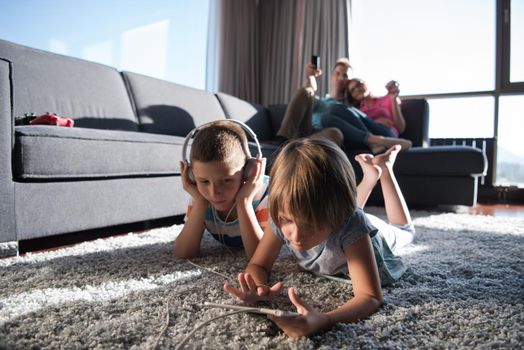 Happy Young Family Playing Together at home.kids using tablet on the floor