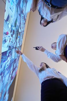 group of female security operators working in a data system control room  Technical Operators Working at  workstation with multiple displays, security guards working on multiple monitors in surveillance room, monitoring cctv and discussing