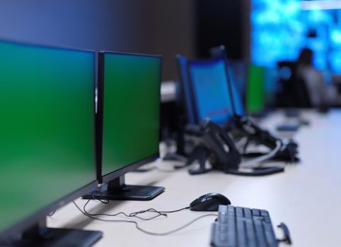 Empty interior of big modern security system control room, workstation with multiple displays, monitoring room with at security data center  Empty office, desk, and chairs at a main CCTV security data center