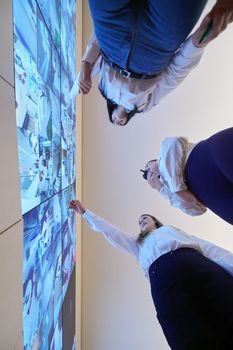 group of female security operators working in a data system control room  Technical Operators Working at  workstation with multiple displays, security guards working on multiple monitors in surveillance room, monitoring cctv and discussing