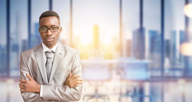 Portrait of young junior businessman in front of his big modern office