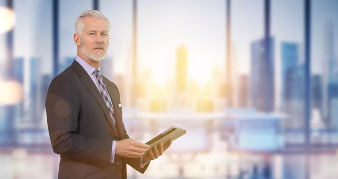 Portrait of senior businessman in front of his modern office with sun flares