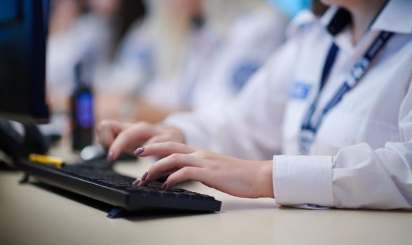 group of female security operators working in a data system control room  Technical Operators Working at  workstation with multiple displays, security guards working on multiple monitors in surveillance room, monitoring cctv and discussing