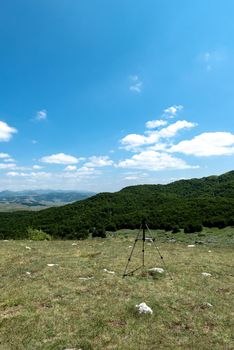 Mountain landscape. Alps with green grass and bright blue sky. Idyllic panorama. Tourism concept. Hiking. Vacation in Europe. Relax in the open air and the spirit of adventure. Ecology of nature.