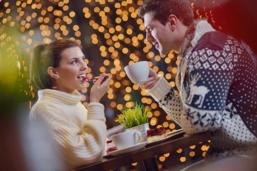 romantic evening date in restaurant  happy young couple with wine glass tea and cake