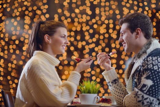 romantic evening date in restaurant  happy young couple with wine glass tea and cake