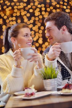 romantic evening date in restaurant  happy young couple with wine glass tea and cake