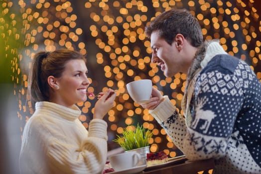 romantic evening date in restaurant  happy young couple with wine glass tea and cake