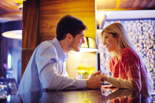 romantic evening date in restaurant  happy young couple with wine glass tea and cake